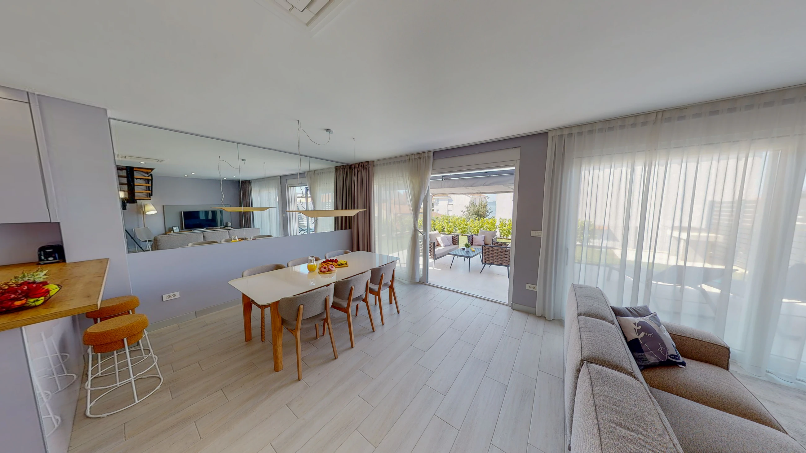 Dining and living area opening outdoors at Three-Bedroom Apartment with Private Pool Near the Sea