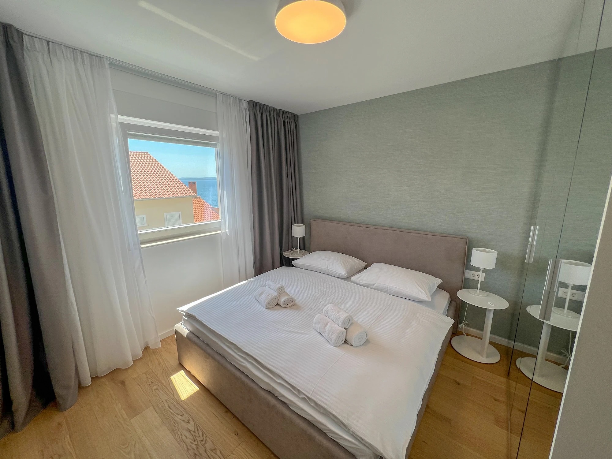 Bright apartment bedroom with a view towards the sea